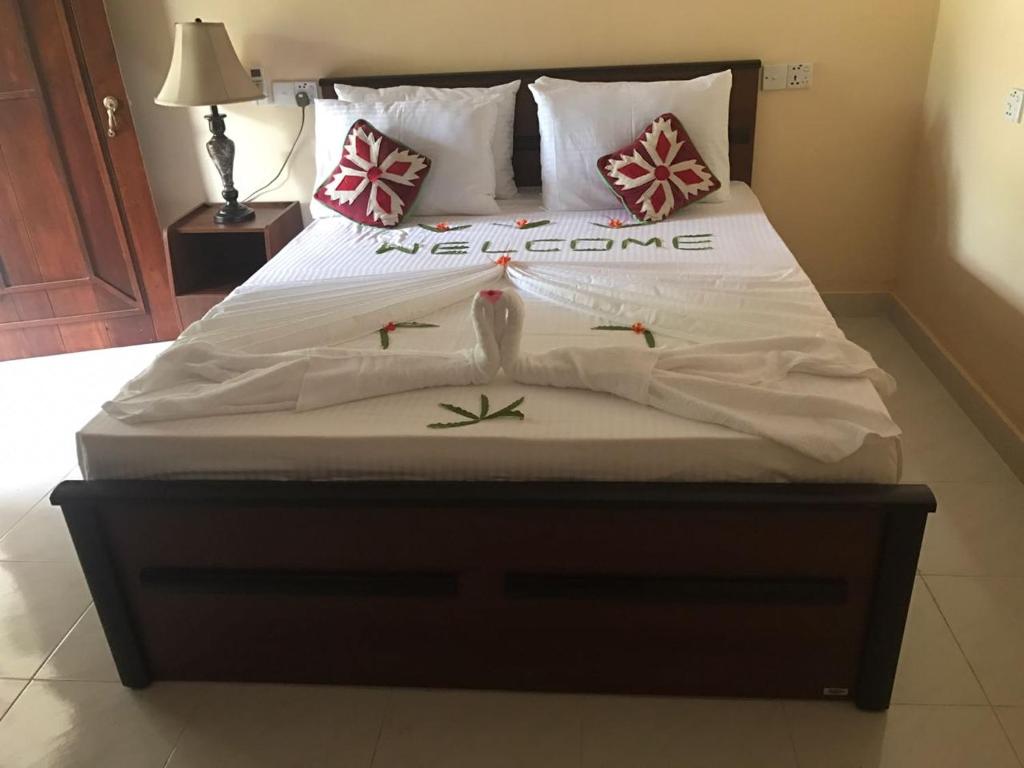 Postel nebo postele na pokoji v ubytování Pidurangala Villas