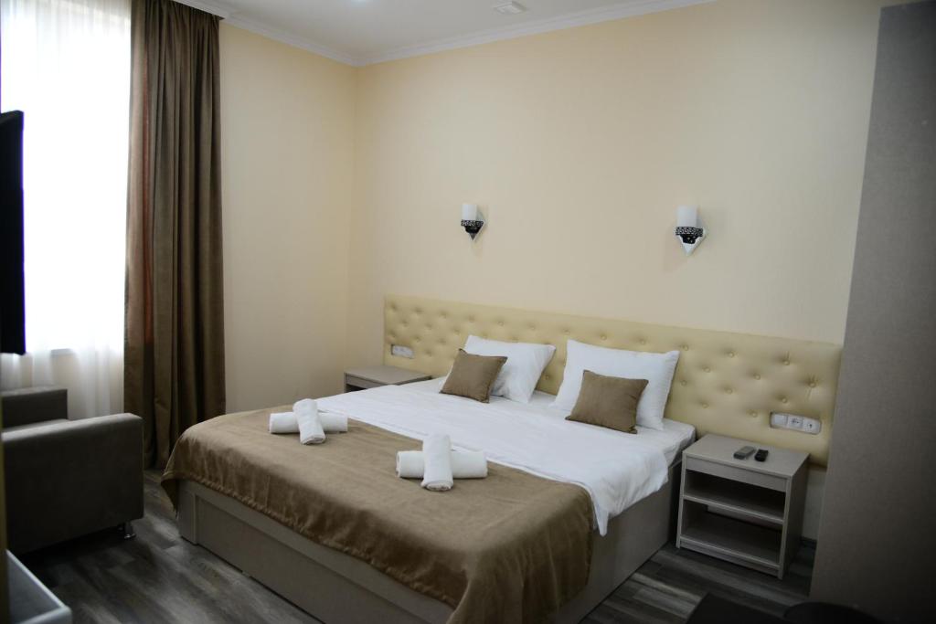 Postel nebo postele na pokoji v ubytování Hotel New Avlabari