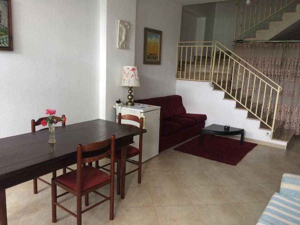 a living room with a table and a couch at Nina Guest House in Tirana