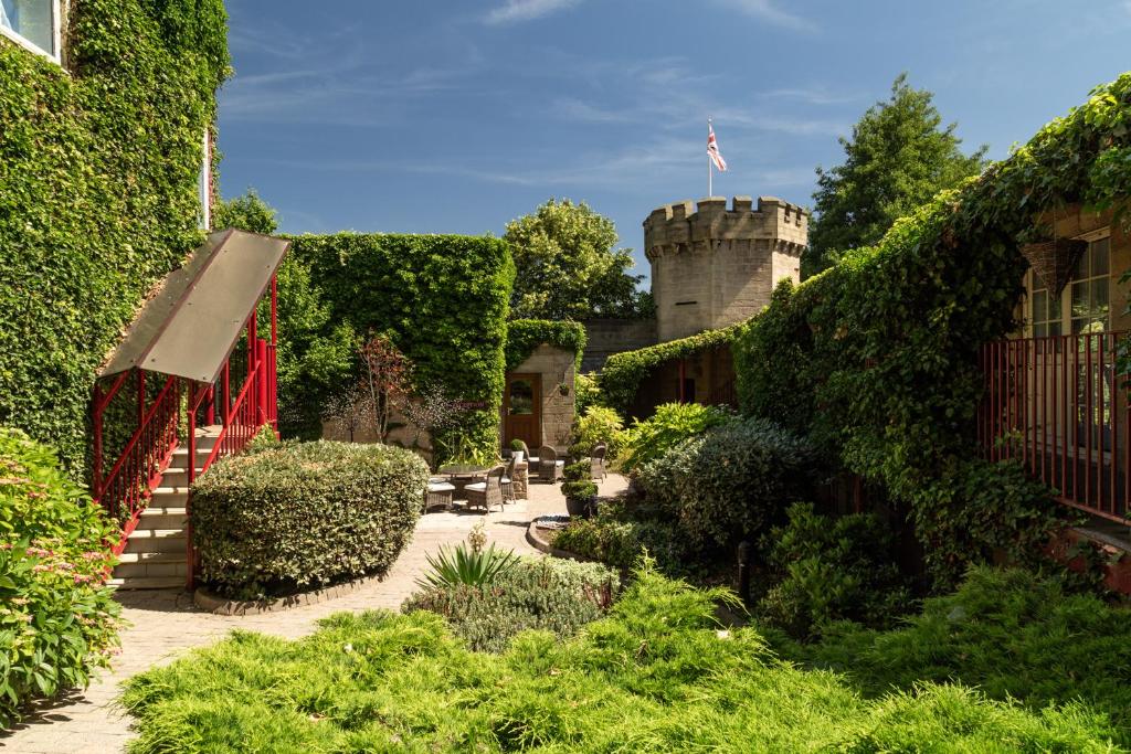 a garden with a castle in the background at Garrison Hotel in Sheffield
