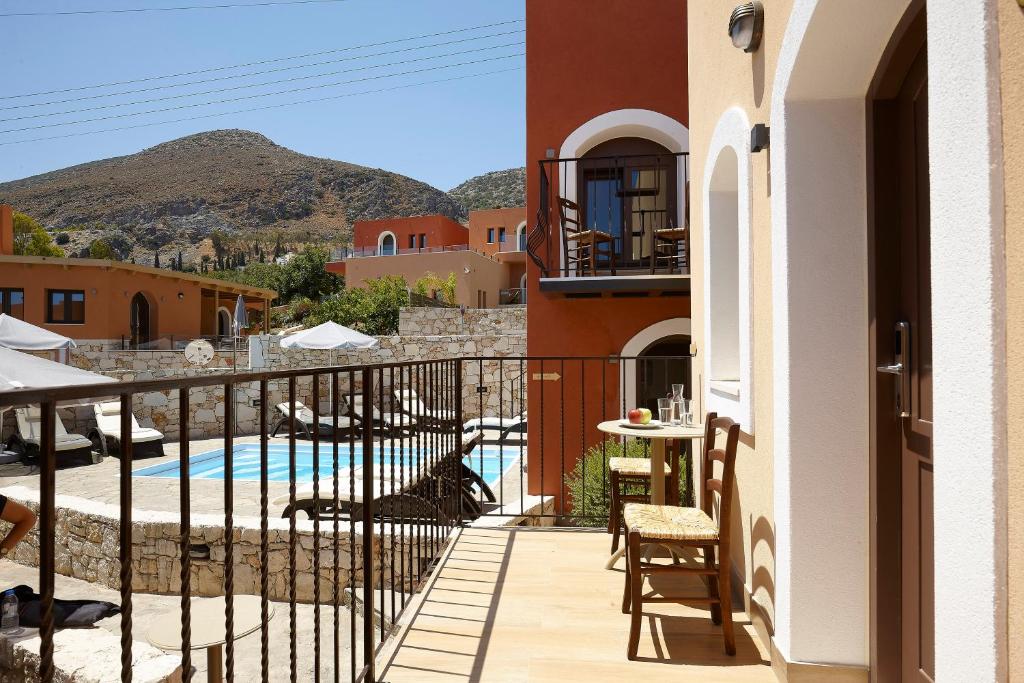 a balcony of a house with a swimming pool at Esperides Resort Crete, The Authentic Experience in Hersonissos