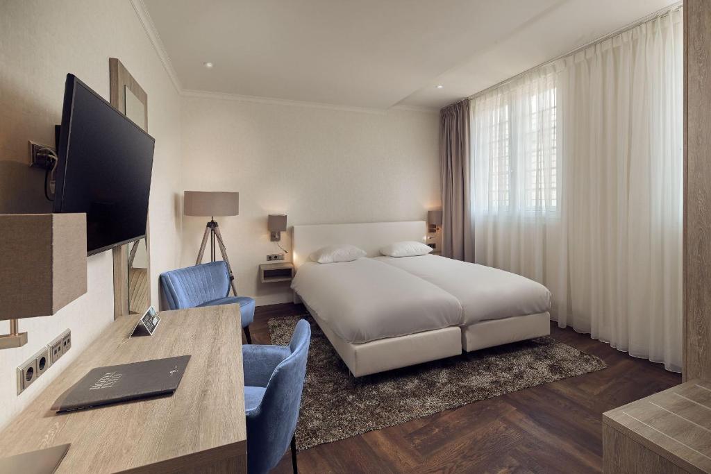 Postel nebo postele na pokoji v ubytování Hotel De Lindeboom