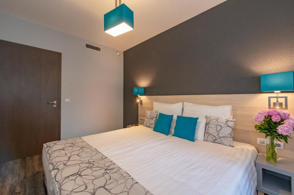 Postel nebo postele na pokoji v ubytování Hotel Regnum Residence