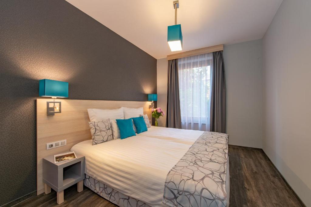 Postel nebo postele na pokoji v ubytování Hotel Regnum Residence