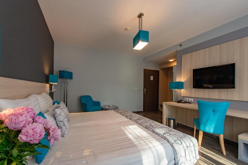 Postel nebo postele na pokoji v ubytování Hotel Regnum Residence