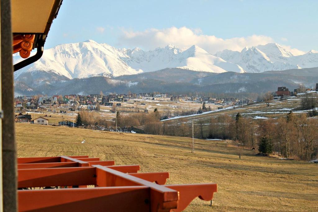 a view of a mountain range with snow covered mountains at ApartHotel Tatry de Luxe FizjoMedical & Spa in Murzasichle