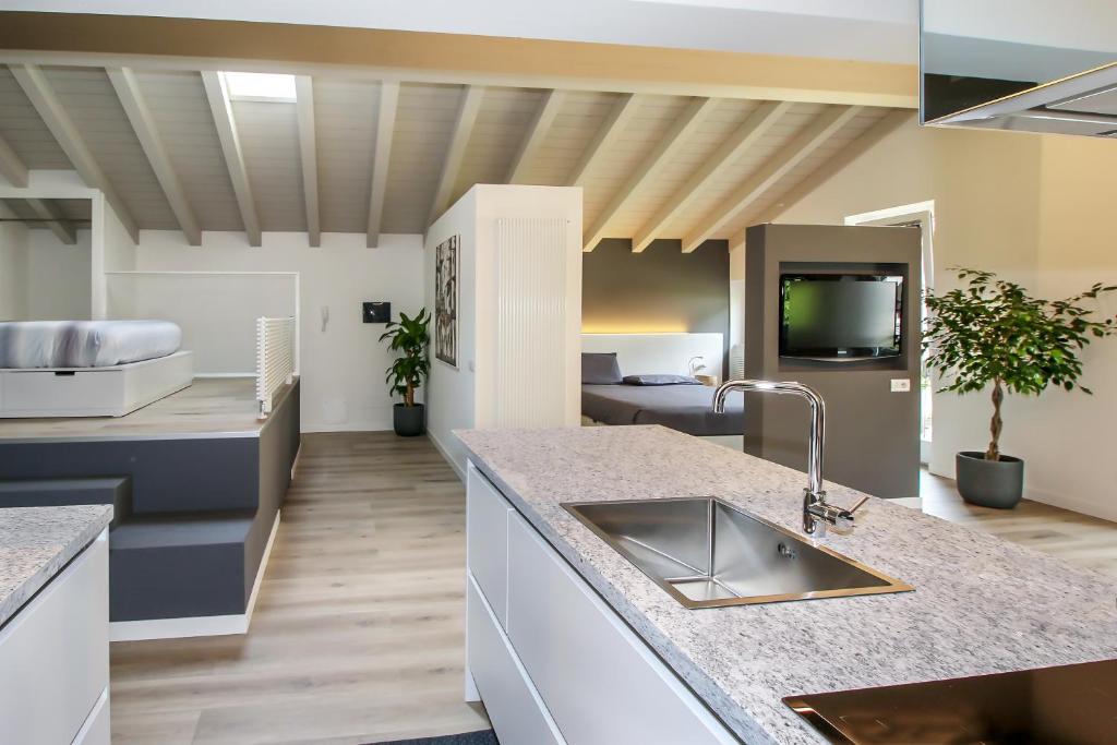 a kitchen with a sink and a counter top at Sofi apartment in Chiavenna