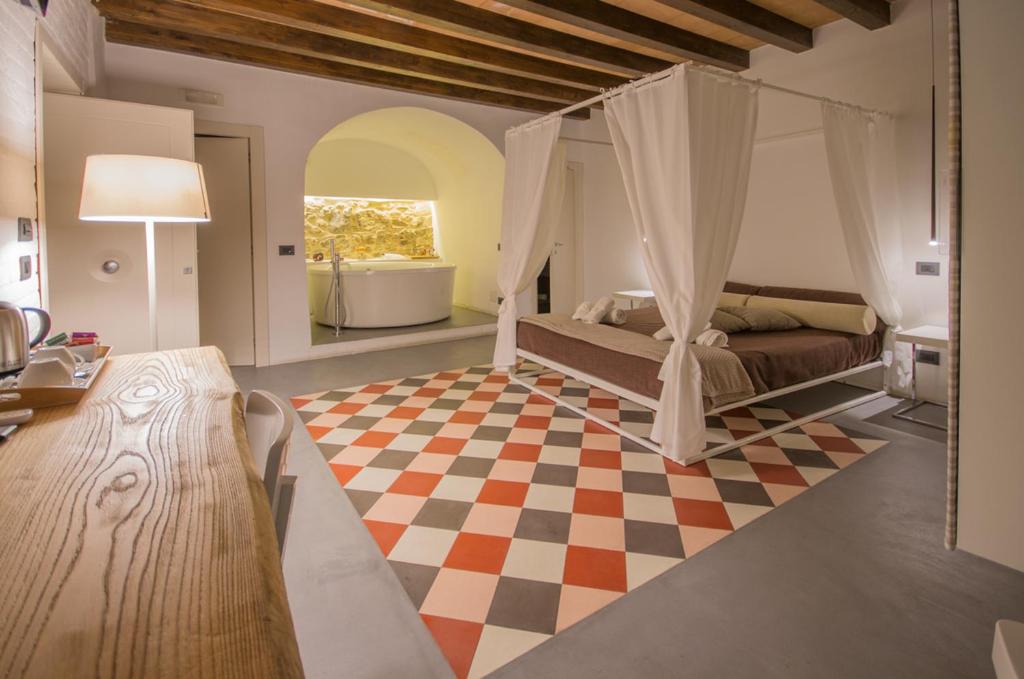 a bedroom with a bed and a checkered floor at Antichi Ricordi in Caltanissetta