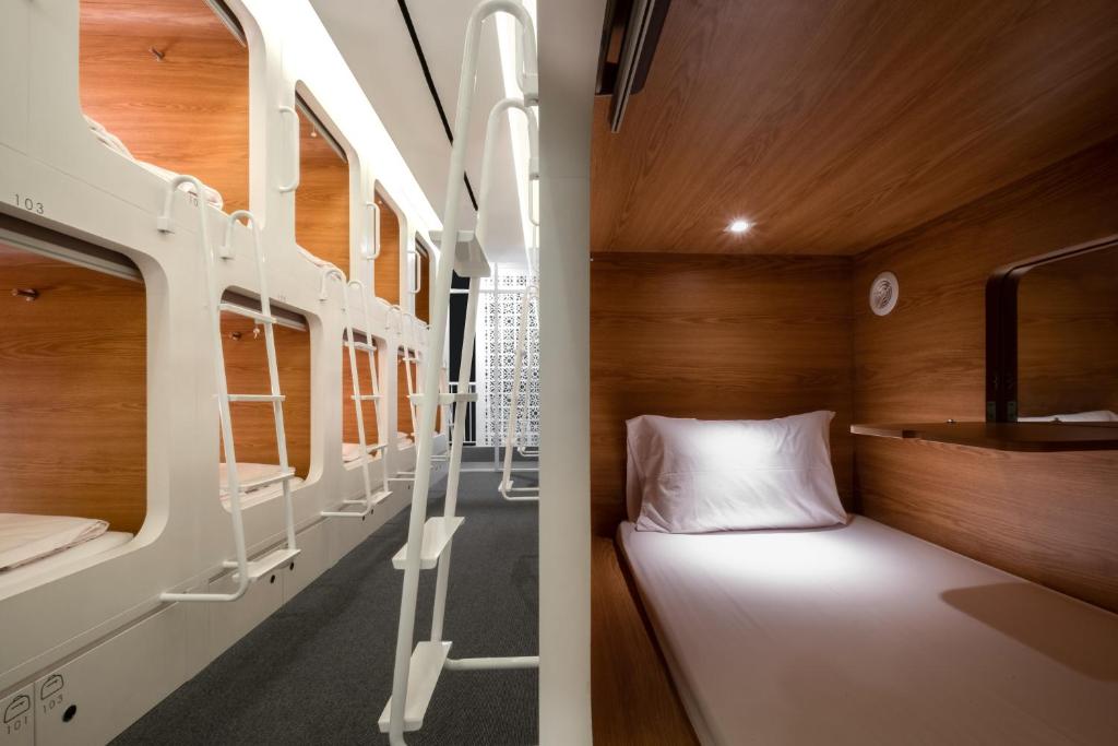 a bedroom with a bunk bed and a bunk room with a bunk bed at KINI Capsule in Jakarta