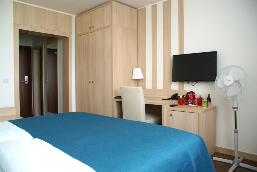 Postel nebo postele na pokoji v ubytování Hotel Metropol