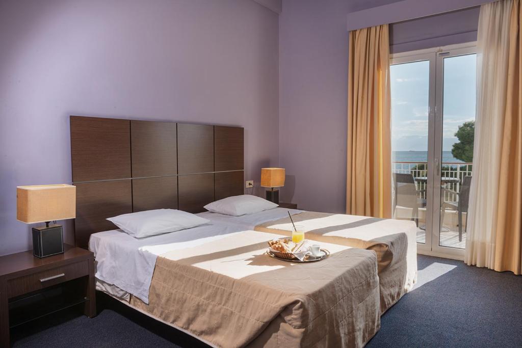 Postel nebo postele na pokoji v ubytování Galini Hotel