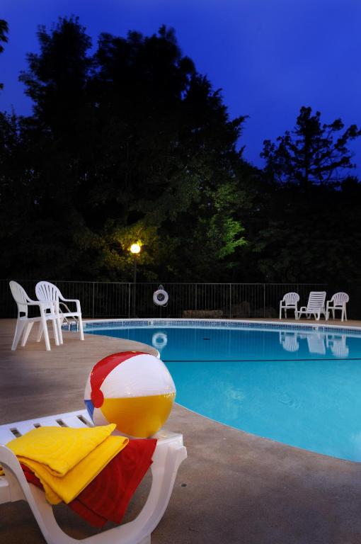 a pool with a lounge chair and a beach ball at Branson's Best in Branson
