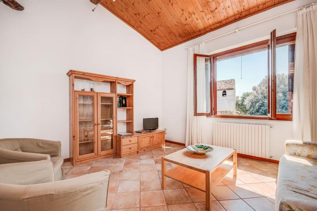 a living room with a couch and a table at Agriturismo La Filanda in Manerba del Garda