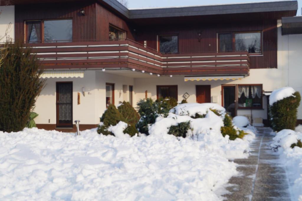 a house with a pile of snow in front of it at Feriendomizil-Sauerland FeWo 2 in Medebach