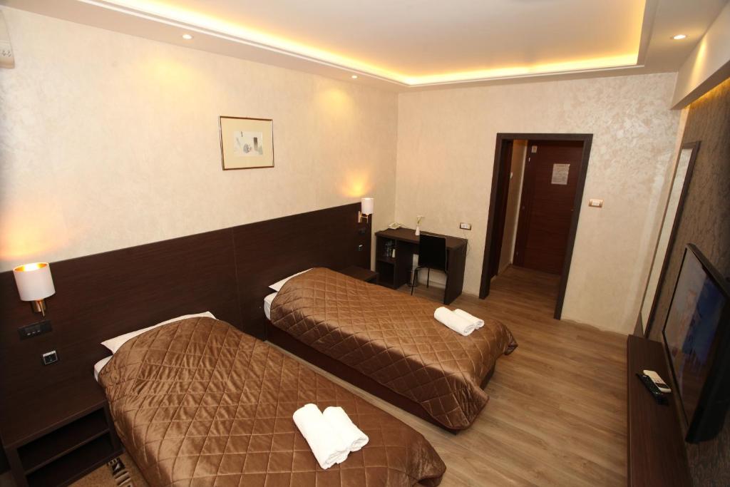 Postel nebo postele na pokoji v ubytování Hotel Petrus