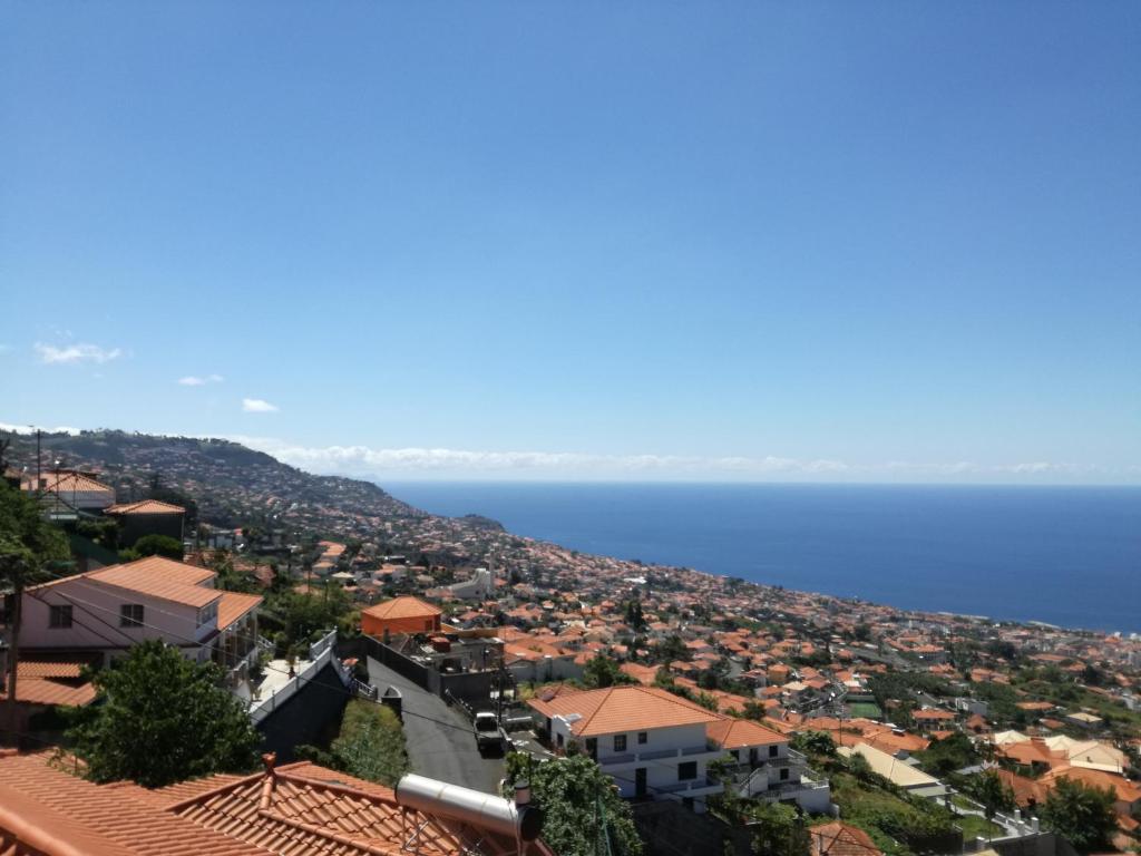 a view of a town with the ocean in the background at The Hill View House in Funchal