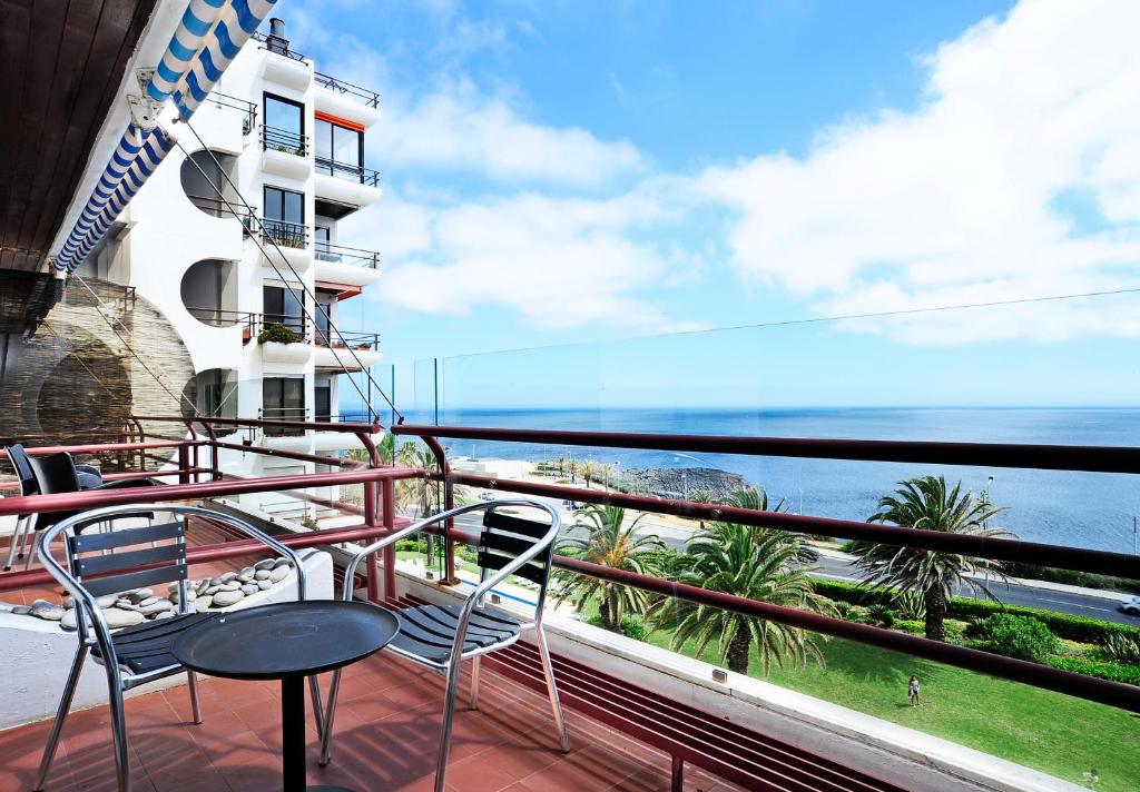 a balcony with chairs and a view of the ocean at Ocean View in Estoril - Checkinhome in Estoril