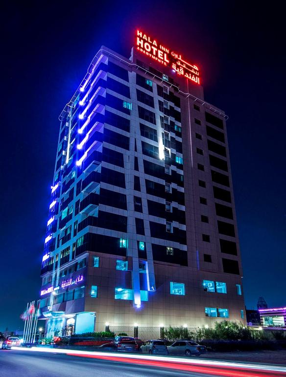a building with a hotel sign on top of it at Hala Inn Hotel Apartments - BAITHANS in Ajman 