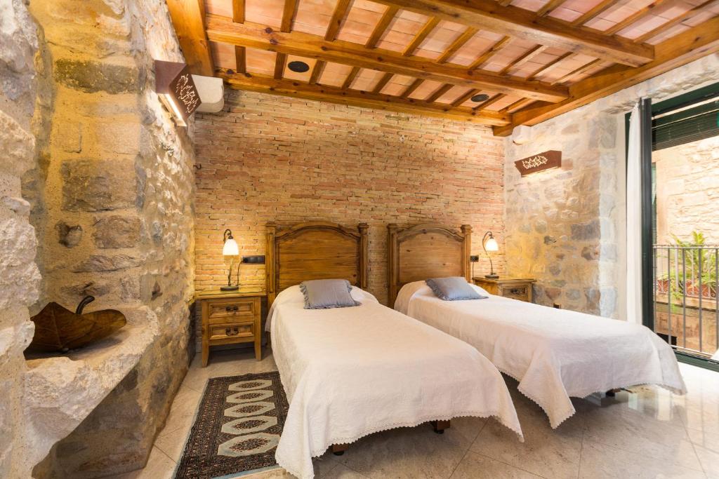 Postel nebo postele na pokoji v ubytování Hotel Històric