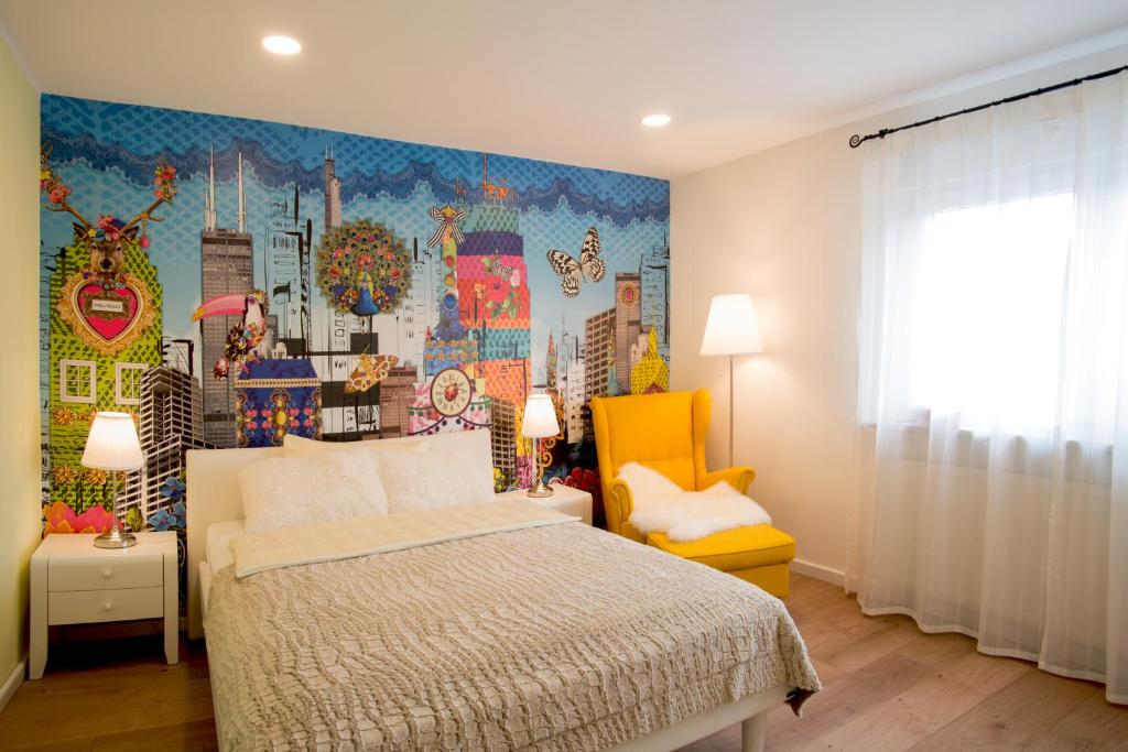 a bedroom with a bed and a colorful wall at Gästehaus A und D Fischer in Mörfelden-Walldorf