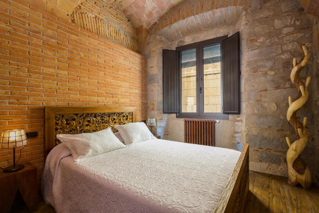 Postel nebo postele na pokoji v ubytování Hotel Històric