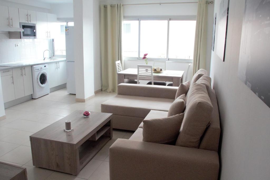 a living room with a couch and a table at Apartamentos Tao Laia in Puerto del Rosario