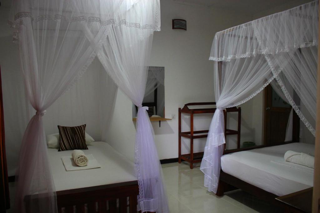 Postel nebo postele na pokoji v ubytování Sigiriya Lahiru Homestay
