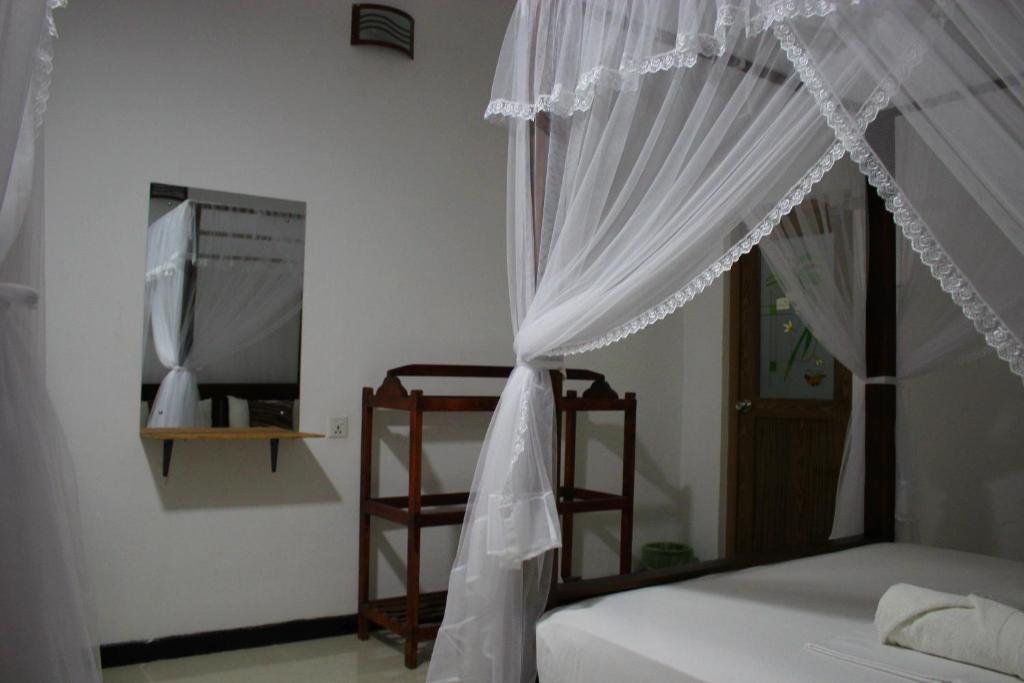 Postel nebo postele na pokoji v ubytování Sigiriya Lahiru Homestay