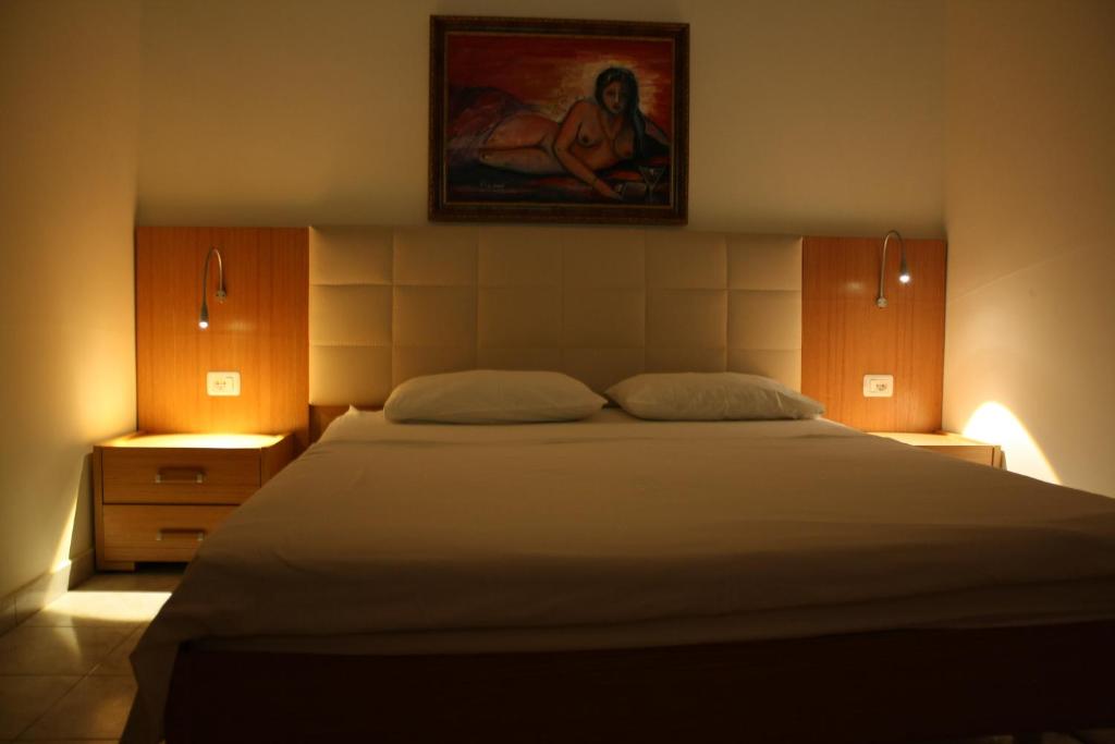 Postel nebo postele na pokoji v ubytování Hotel Martini