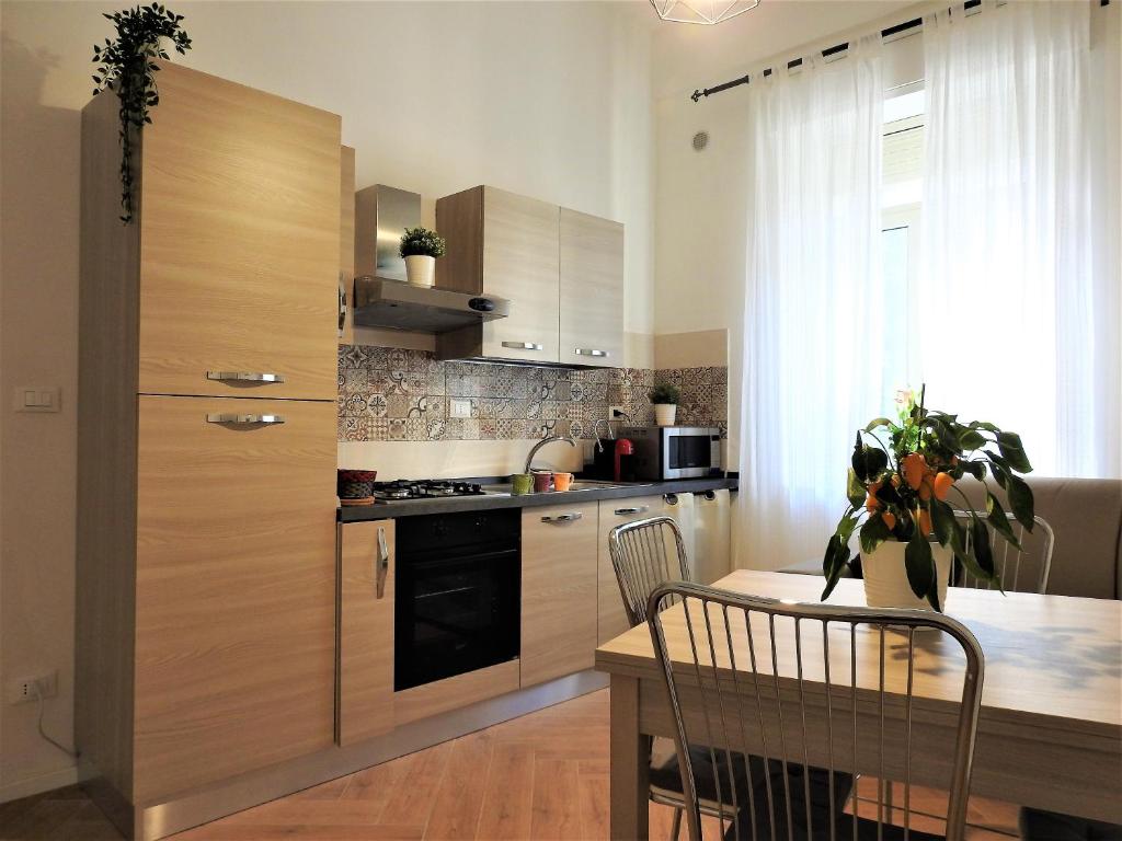 a kitchen with a table and a wooden cabinet at Casa Pinco in Siracusa