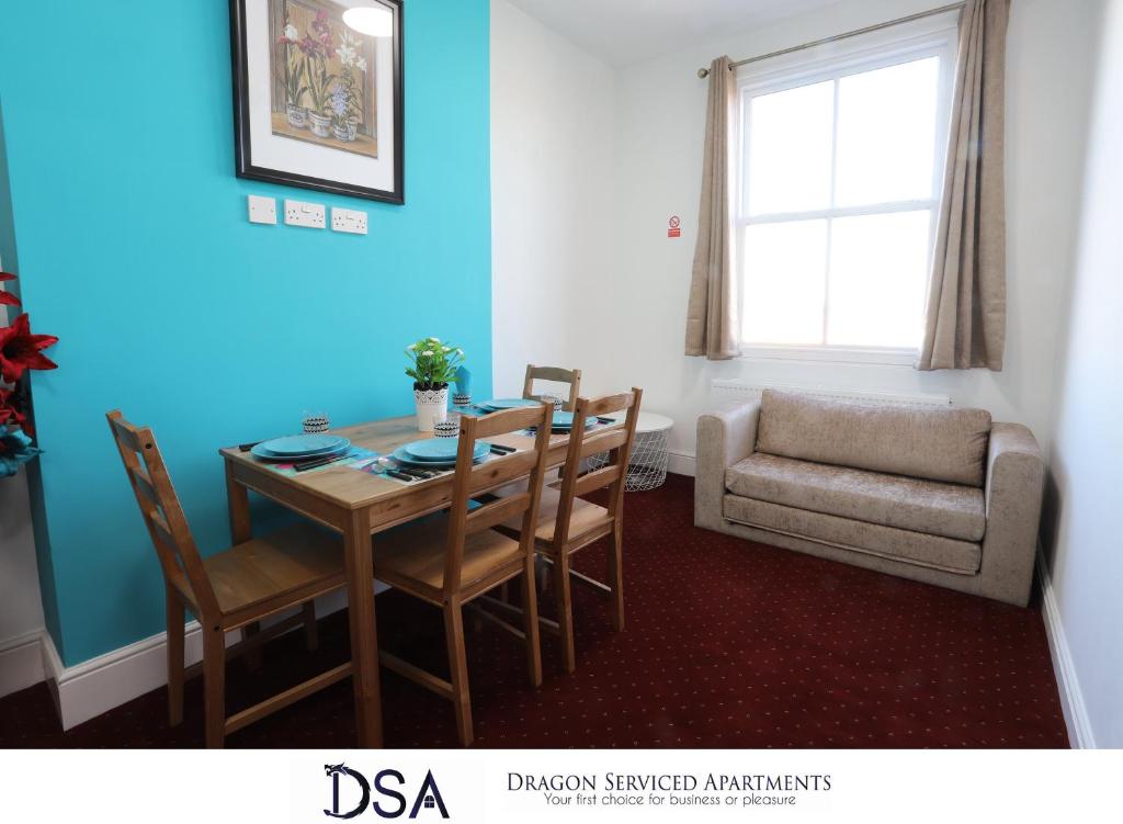 a dining room with a table and chairs and a couch at Birmingham Central Station Apartment (Flat 5) in Birmingham