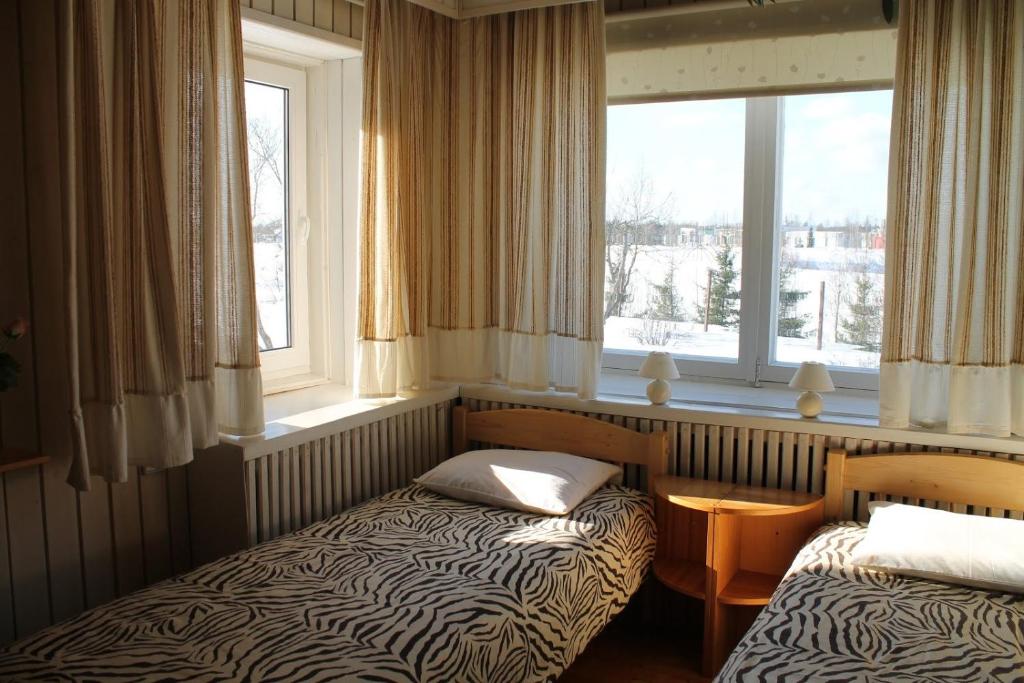 瓦爾加的住宿－光明旅館，窗户前设有两张床的房间