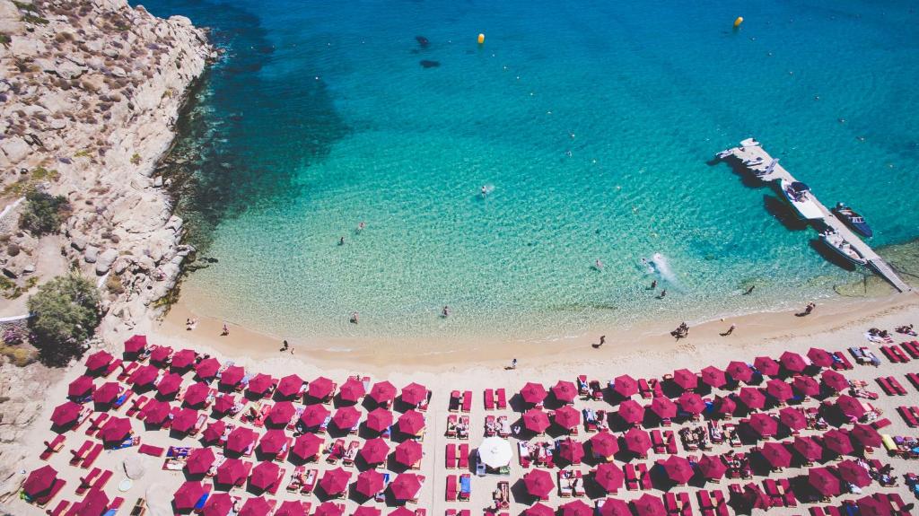 an aerial view of a beach with pink umbrellas at Super Paradise Hotel in Super Paradise Beach