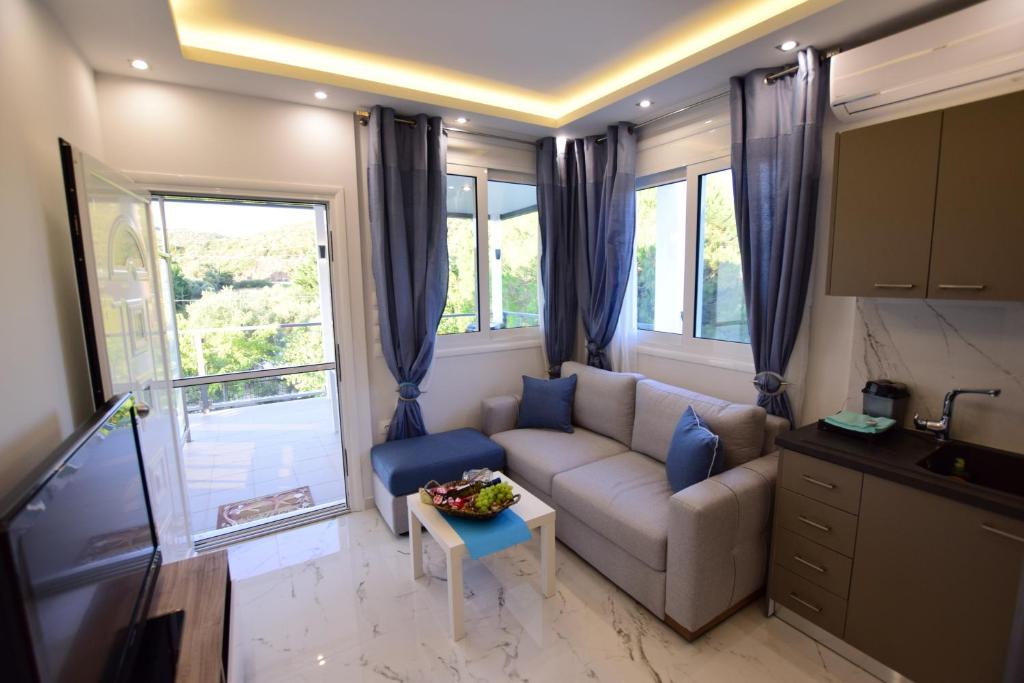 a living room with a couch and a table at Vista Luxury Suites Toroni Halkidiki 1BR in Toroni