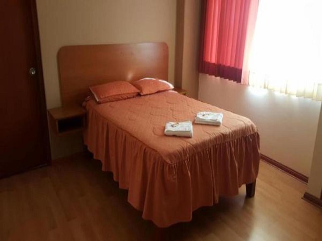 Postel nebo postele na pokoji v ubytování Hotel Arunta