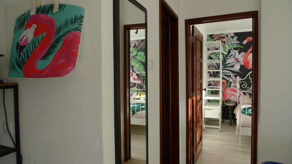 a hallway with two mirrors and a wall with paintings at Lei Home in Cascais