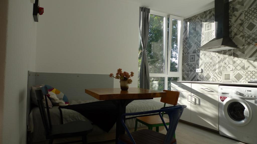 a small kitchen with a table and a microwave at Lei Home in Cascais