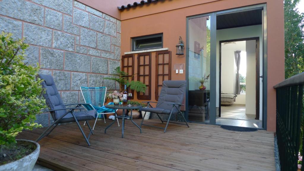 a patio with chairs and a table and a building at Lei Home in Cascais