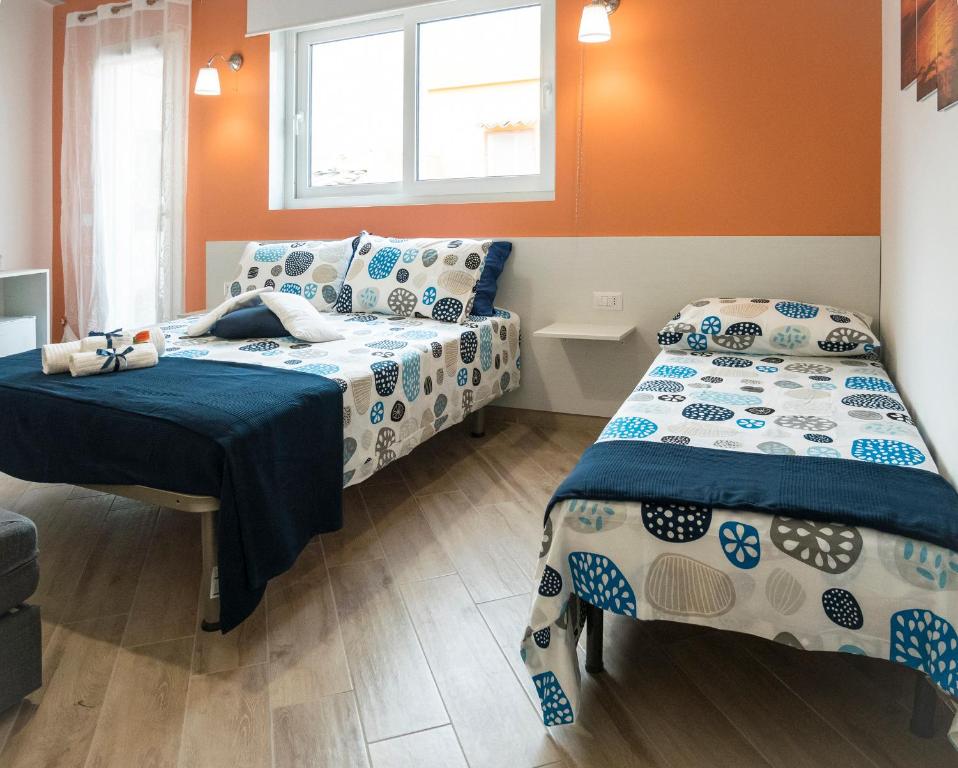 Łóżko lub łóżka w pokoju w obiekcie Casa Rossini