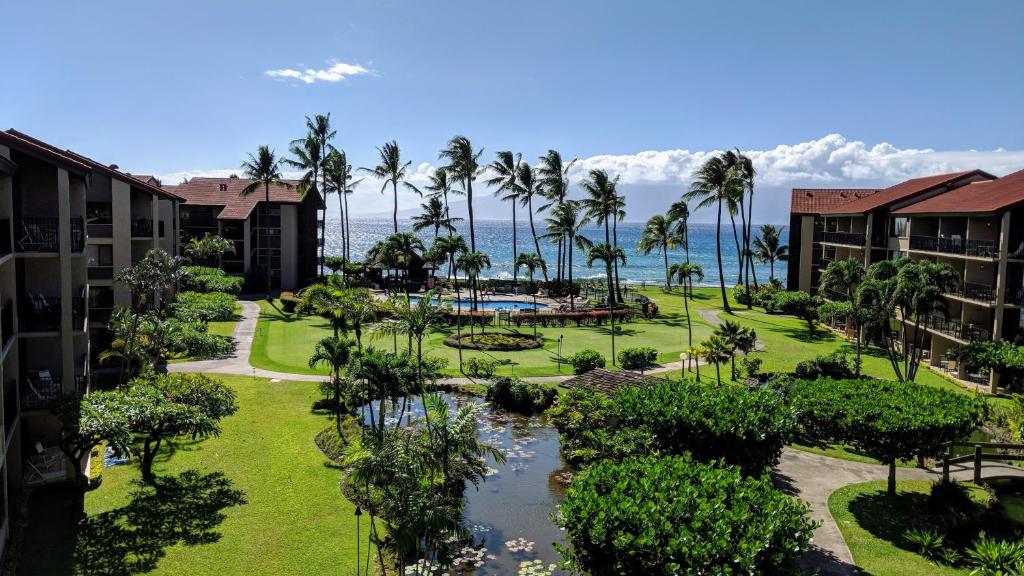 an aerial view of a resort with a pool and palm trees at Papakea #H401 in Lahaina