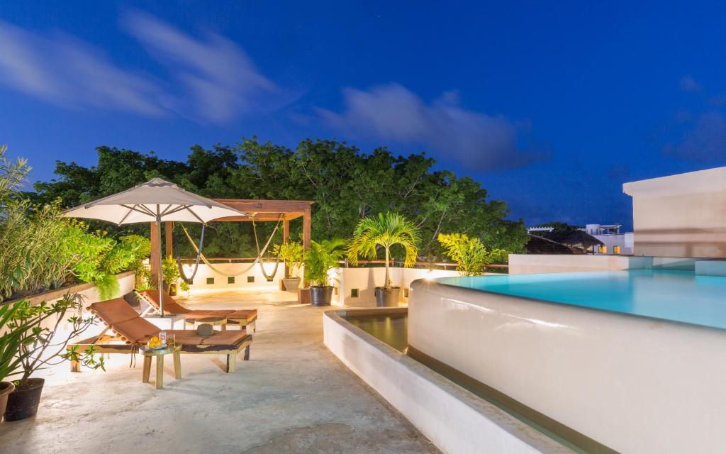 a villa with a swimming pool and a resort at Quinta Margarita - Boho Chic Hotel in Playa del Carmen