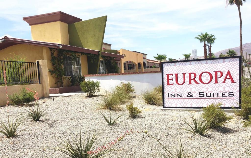 a sign for the entrance to a inn and suites at Europa Inn & Suites in Desert Hot Springs