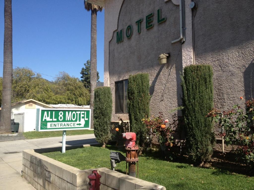 a red fire hydrant in front of a motel at All 8 Motel in Azusa