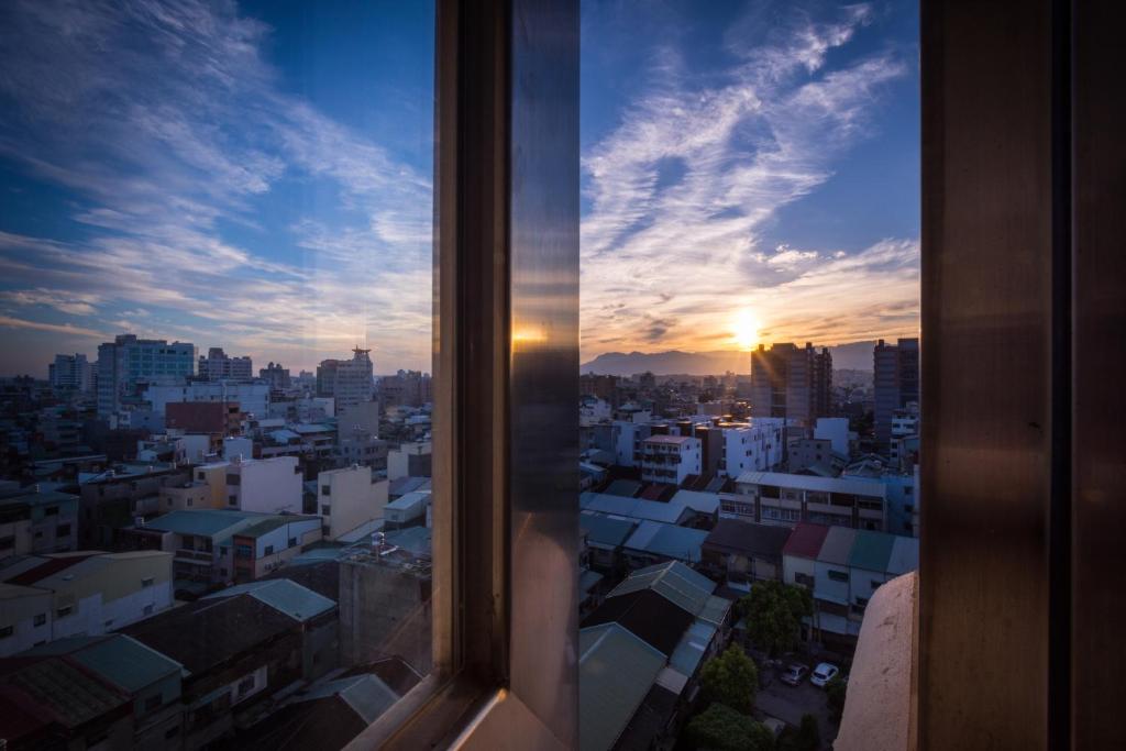a view from a window of a city at sunset at HOTEL HI - Xinmin in Chiayi City