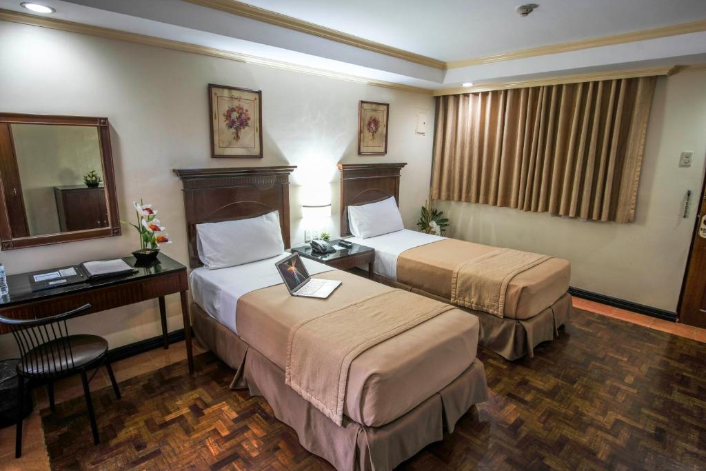 Postel nebo postele na pokoji v ubytování Fersal Hotel - P. Tuazon Cubao