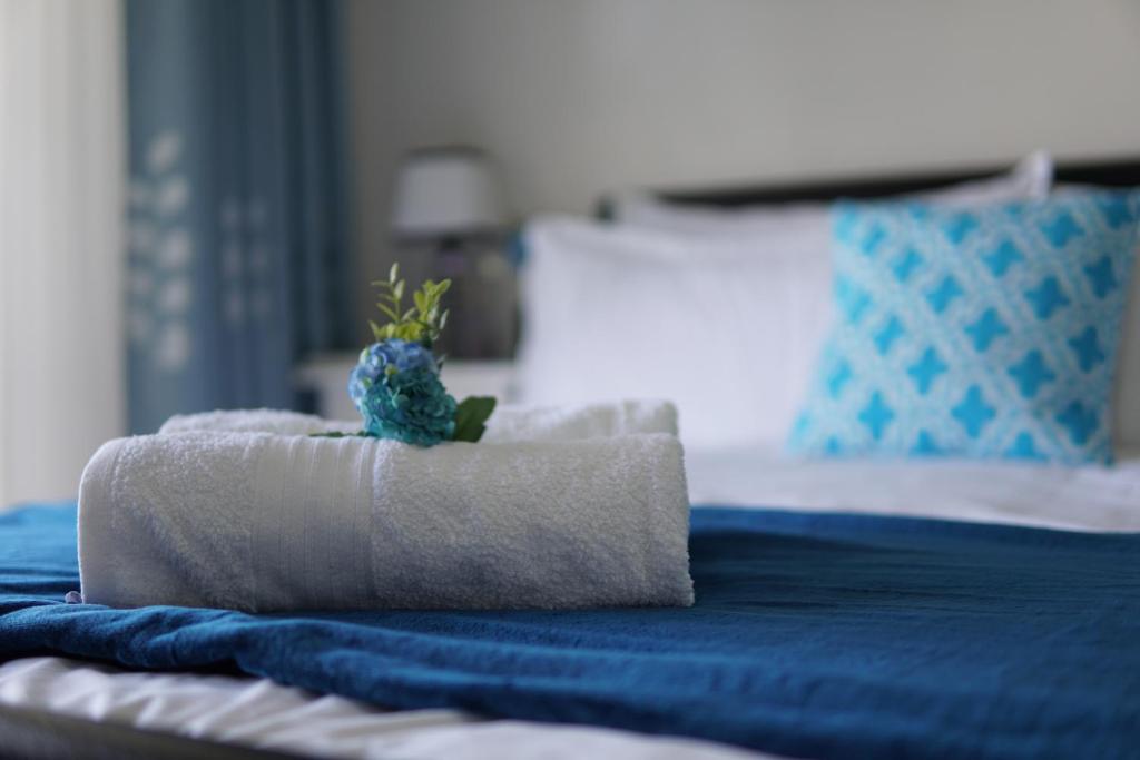 a pile of towels sitting on top of a bed at Ohana at Tagaytay Prime in Tagaytay