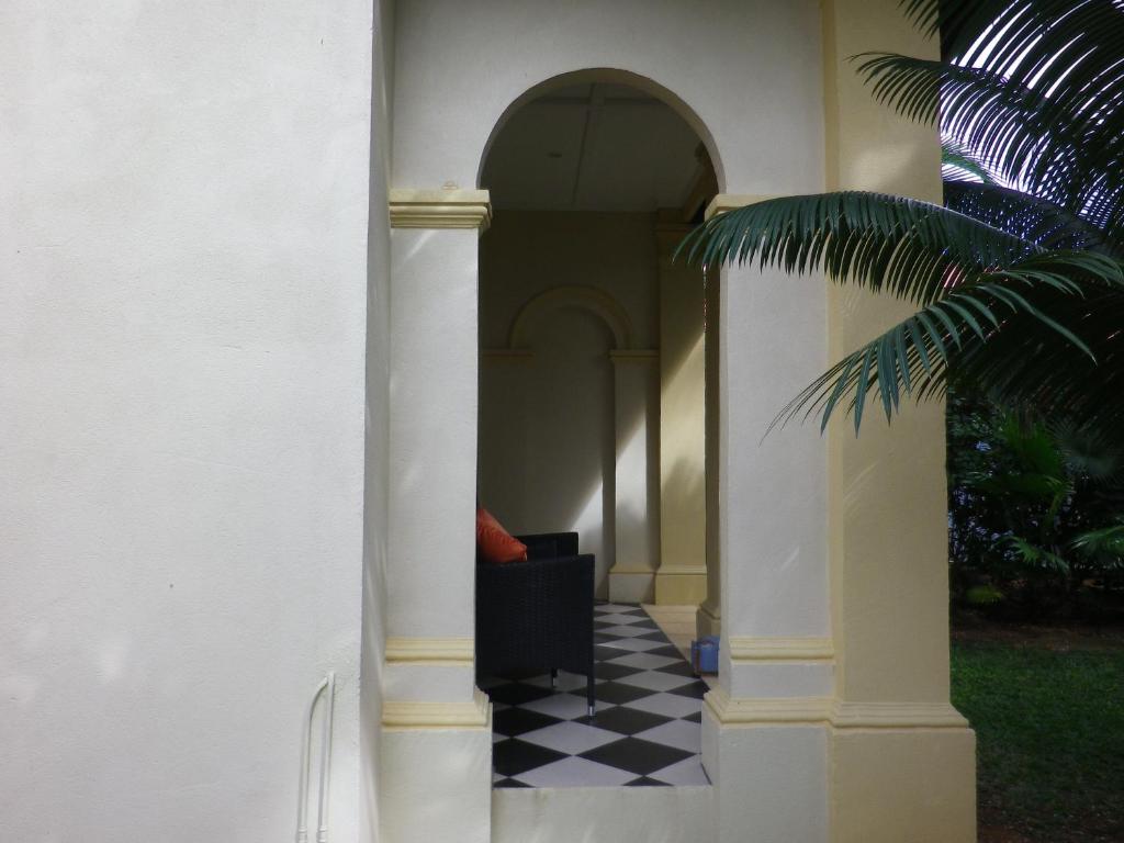 a hallway of a house with a black and white checkered floor at Villa Papaya in Flying Fish Cove