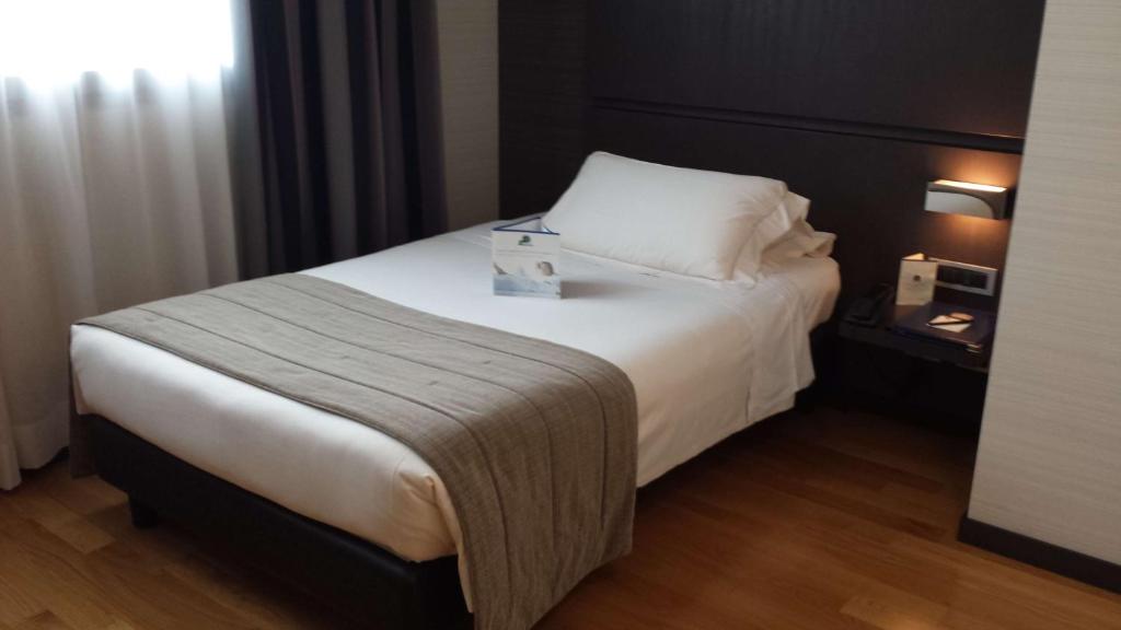 Postel nebo postele na pokoji v ubytování Best Western Plus Hotel Monza e Brianza Palace