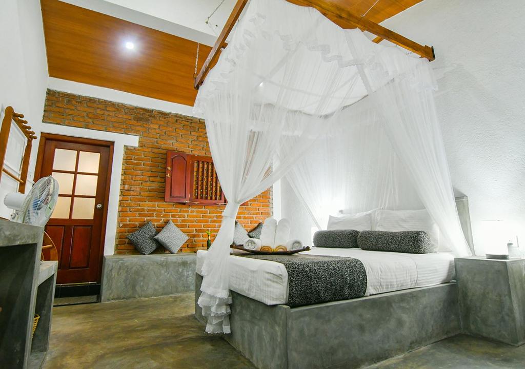 Postel nebo postele na pokoji v ubytování Thotupola Residence