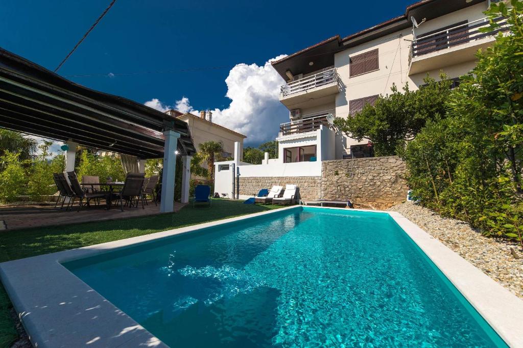 a swimming pool in the backyard of a house at Apartments Agape in Crikvenica